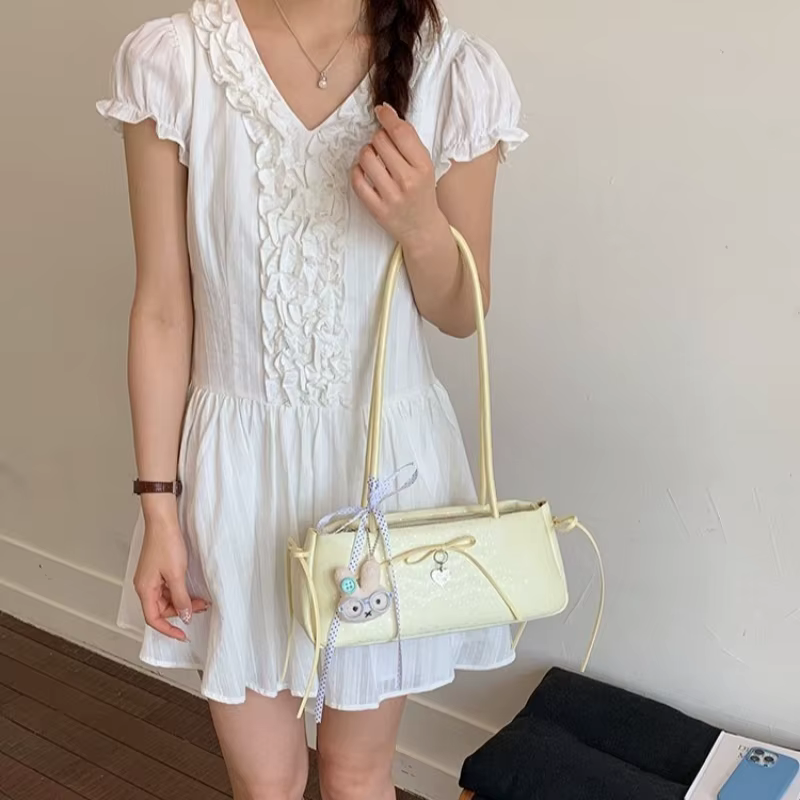 Sac à bandoulière long pour femme avec nœud à pois et breloque cœur