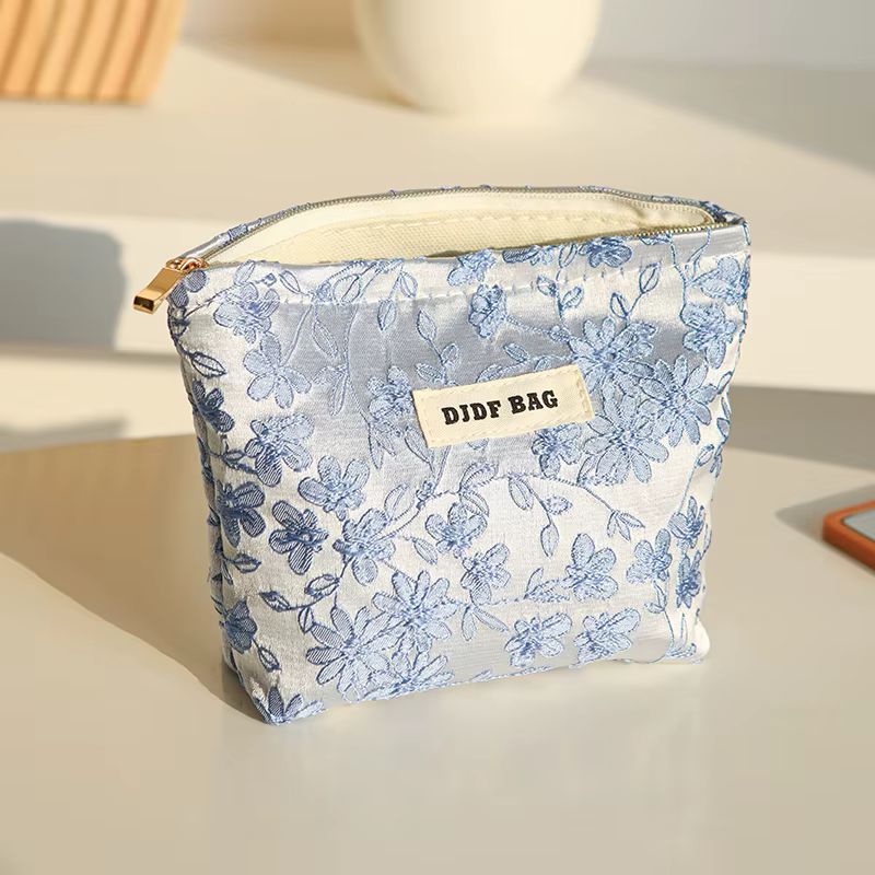 Nouveau sac cosmétique femme de petite taille Portable bleu broderie Mini sac de rangement de serviettes hygiéniques sac de clé de monnaie de banlieue sac de carte bancaire